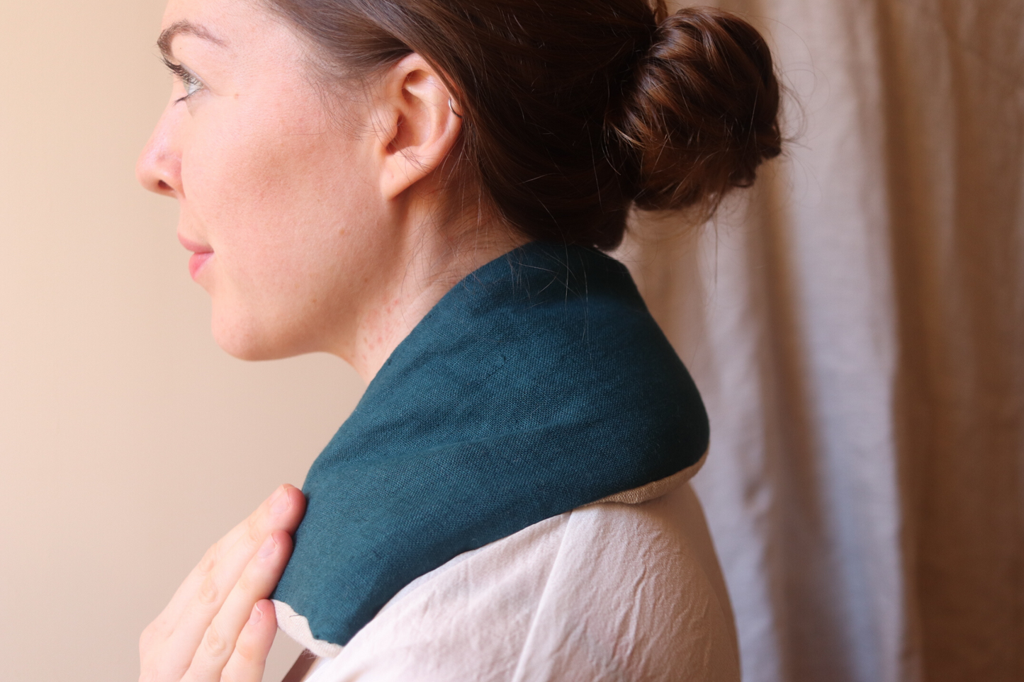 Woman with blue heat pack over shoulders