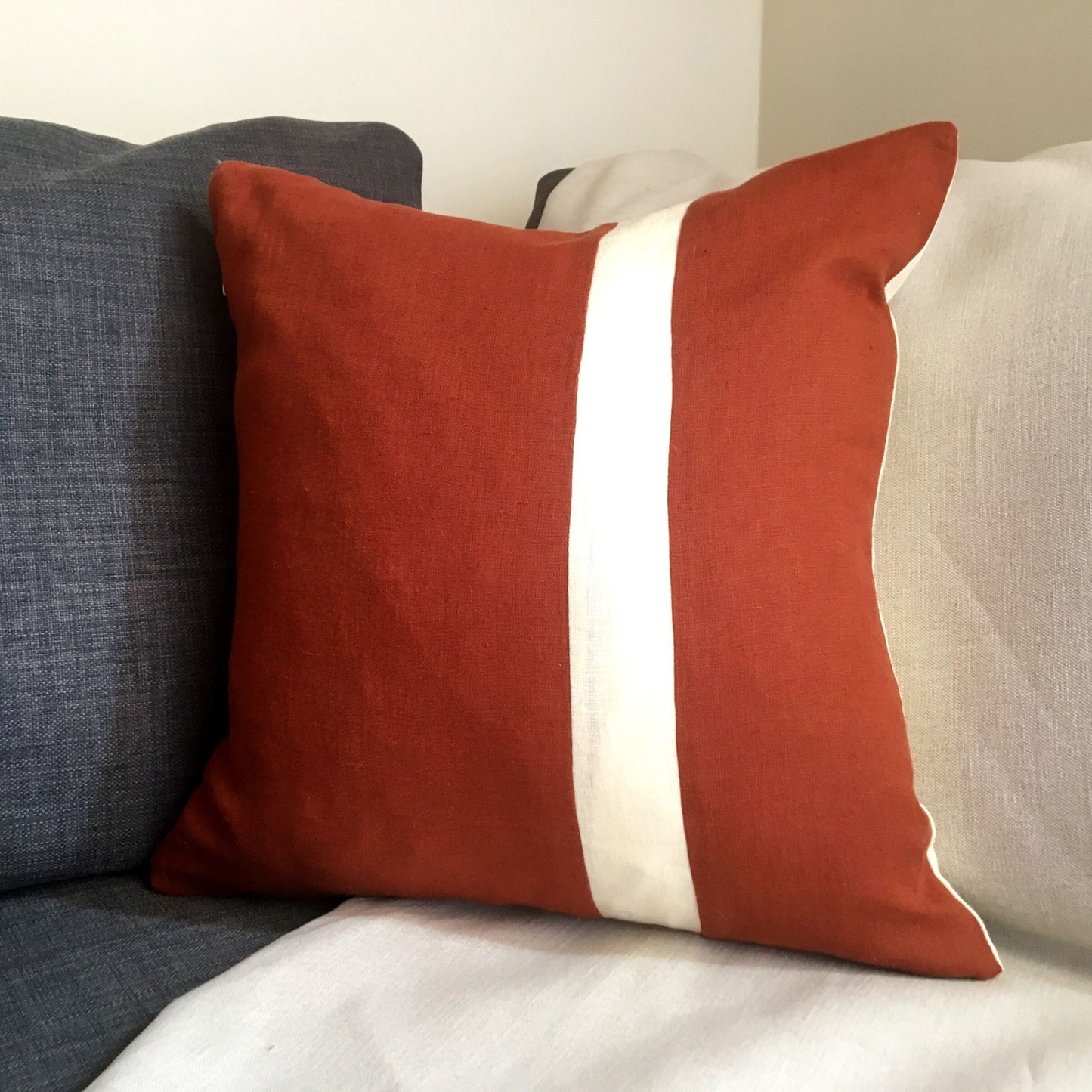 Red squirrel cushion stripe front on grey sofa