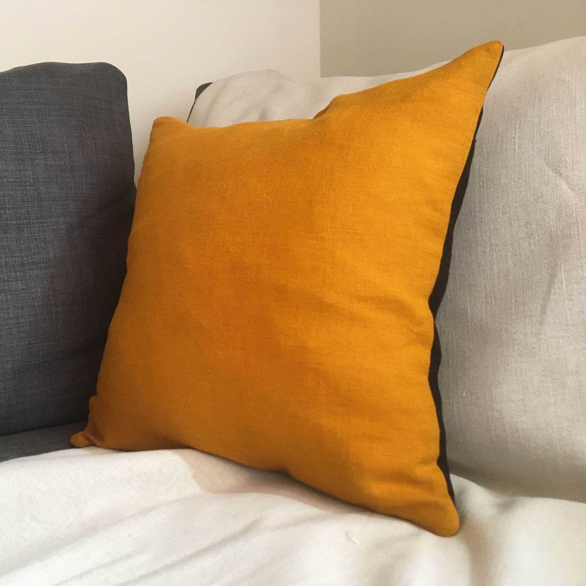 Bee cushion on grey sofa