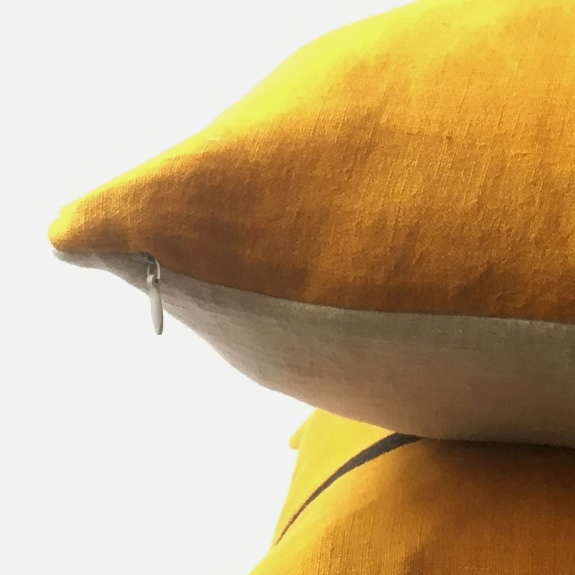 yellow cushion cover, neutral base with zip closed