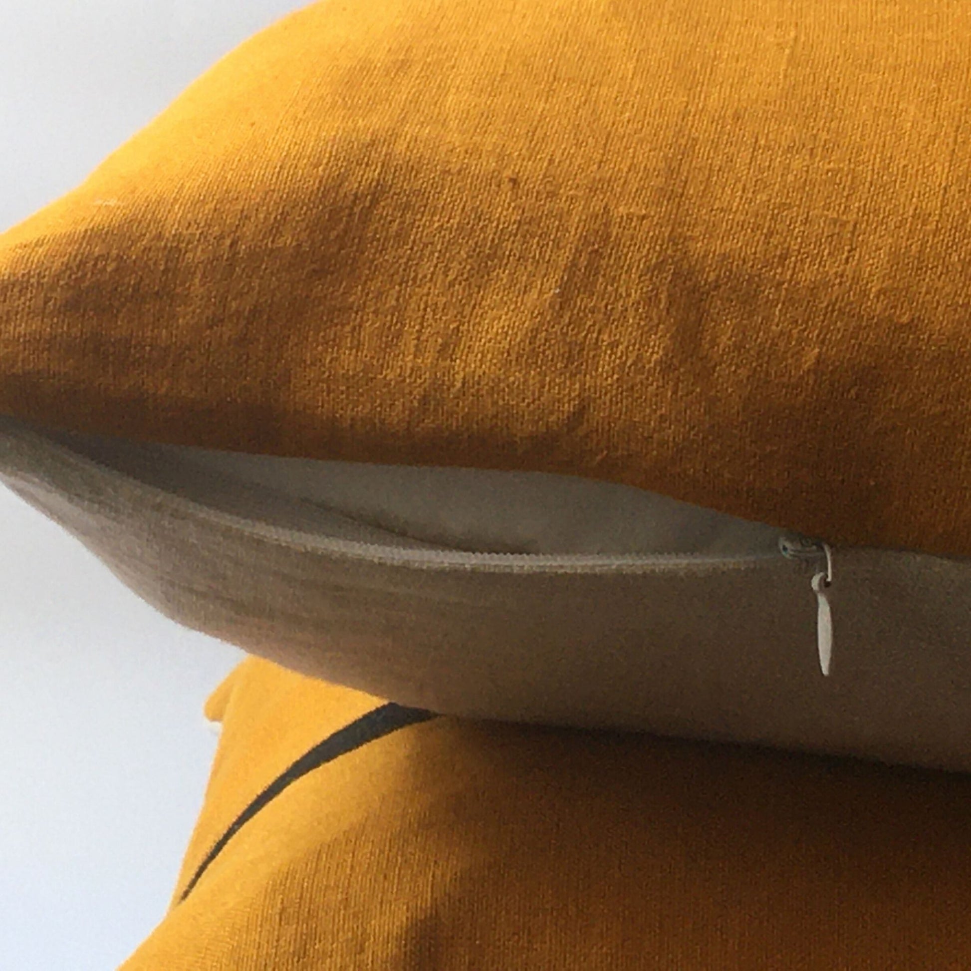 yellow cushion cover, neutral base with zip open