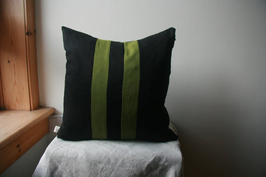 Black cushion cover with two parallel green stripes equally spaced from centre